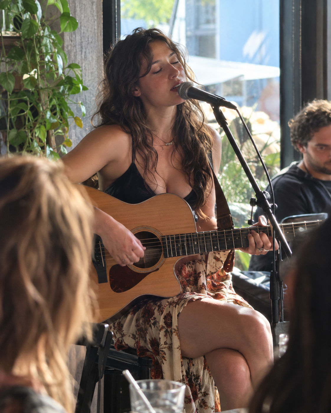 A singer performing with an acoustic guitar